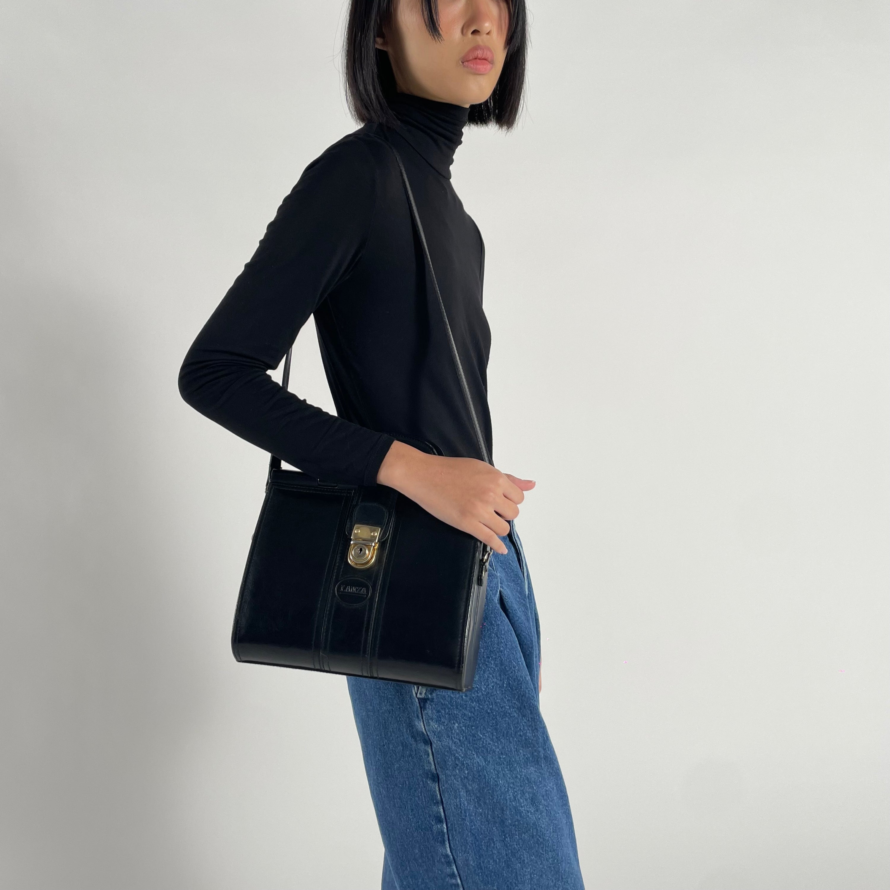 Vintage 1980s signed Lanza Black Leather bag with push lock button
